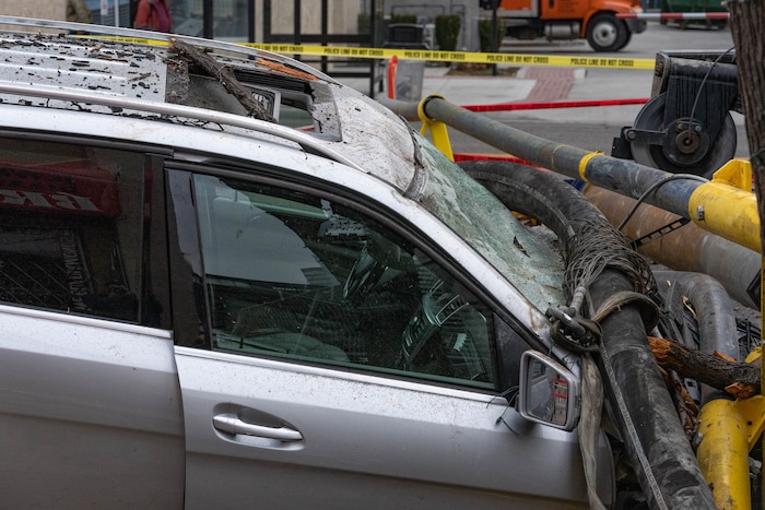(Francisco Kjolseth | The Salt Lake Tribune) A collapsed drill rig is seen on Wednesday, March 16, 2022, at the intersection of State Street and 200 South. The rig toppled over Tuesday night at the site of the new Astra Tower, crushing two unoccupied parked cars and sending the crane operator to the hospital in serious condition.