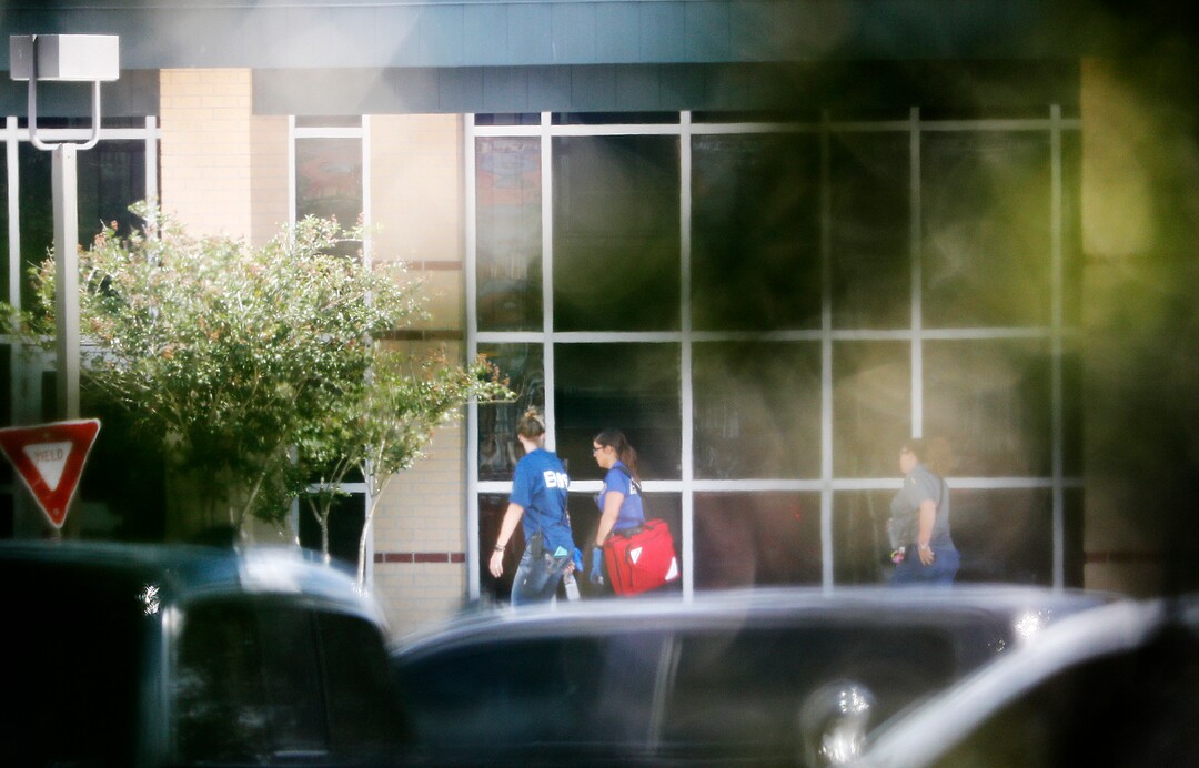 Emergency Medical Service personnel walk in front of Santa Fe High School after a shooting on Friday, May 18, 2018, in Santa Fe, Texas. (Kevin M. Cox /The Galveston County Daily News via AP)