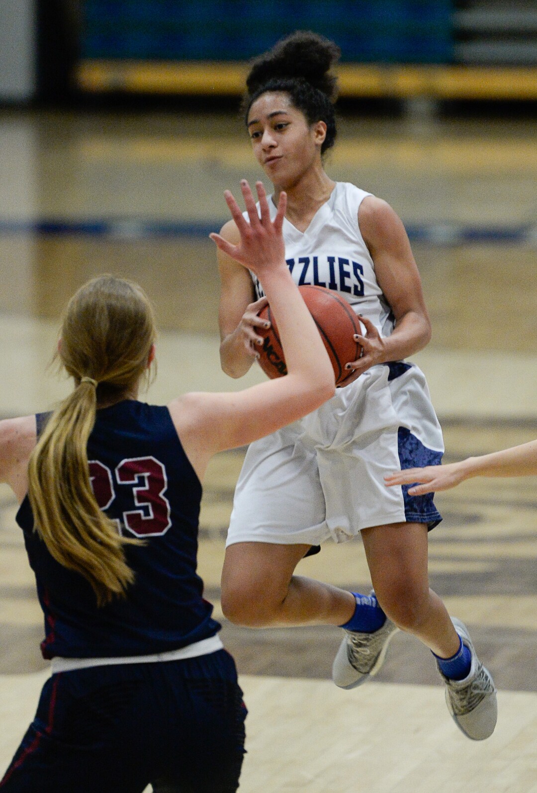 (Francisco Kjolseth  |  The Salt Lake Tribune)  Eleyana Tafisi of Copper Hills fakes a pass in the air over Herriman in game action in West Jordan on Thursday, Jan. 25, 2018.