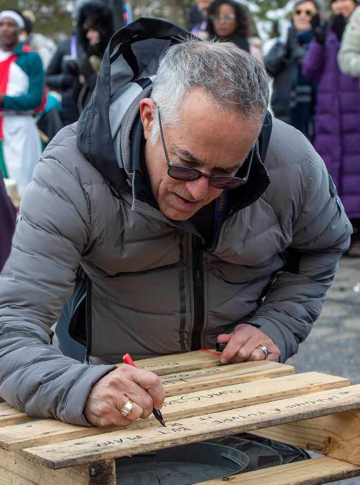 (Rick Egan  |  The Salt Lake Tribune)      John Cooper, the festival's director, signs a pallet before it was tossed onto the first-ever Sundance bonfire, a community gathering on Swede Alley, in Park City, Thursday, Jan. 30, 2020.