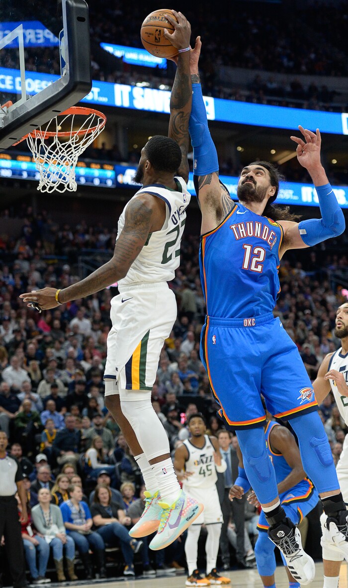 (Francisco Kjolseth  |  The Salt Lake Tribune)  Utah Jazz forward Royce O'Neale (23) gets blocked by Oklahoma City Thunder center Steven Adams (12) as the Utah Jazz host the Oklahoma City Thunder in their NBA basketball game at Vivint Smart Home Arena in Salt Lake City on Mon. Dec. 9, 2019.