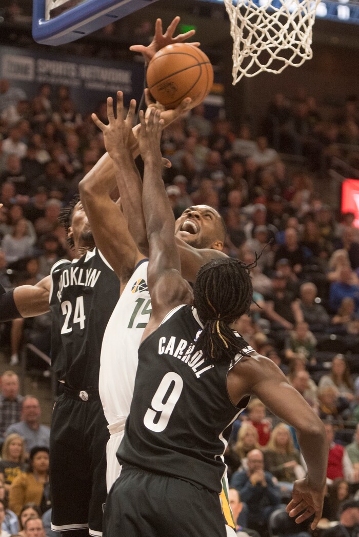 (Rick Egan  |  The Salt Lake Tribune) Utah Jazz forward Derrick Favors (15) tries to get a shot off, as Brooklyn Nets forward Rondae Hollis-Jefferson (24) and DeMarre Carroll (9), in NBA action, Utah Jazz vs. Brooklyn Nets, in Salt Lake City, Saturday, November 11, 2017.