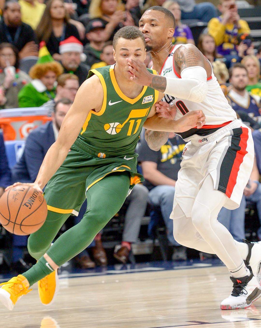 Leah Hogsten  |  The Salt Lake Tribune  Portland Trail Blazers guard Damian Lillard (0) hits Utah Jazz guard Dante Exum (11) in the face on a drive. The Utah Jazz defeated the Portland Trail Blazers, 117-96, Christmas night at Vivint Smart Home Arena.