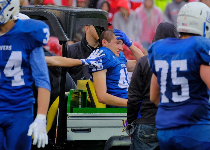 (Leah Hogsten  |  The Salt Lake Tribune) Beaver players console Cole Marshall as he leaves the field with an injured ankle.  Beaver High School boys' football team defeated Delta High School 35-16 during their class 2A state semifinal football game Saturday, November 4, 2017 at Weber State University's Stewart Stadium.