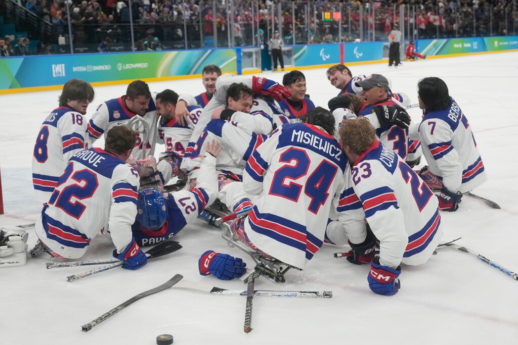 (Luca Bruno | AP) U.S. players celebrate after winning the gold medal at the end of the ice hockey match between United States and Canada at the 2026 Winter Paralympics, in Milan, Italy, Sunday, March 15, 2026.