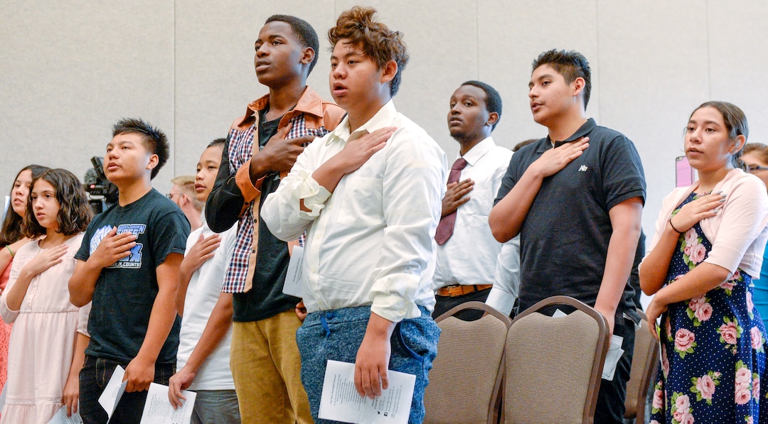 Leah Hogsten  |  The Salt Lake Tribune  With hands on their heart 21 participants, ages 5 to 22, representing 8 countries, spoke the oath of citizenship as America's newest citizens during a youth naturalization ceremony at the Viridian Event Center in West Jordan, Monday, August 6, 2018. 