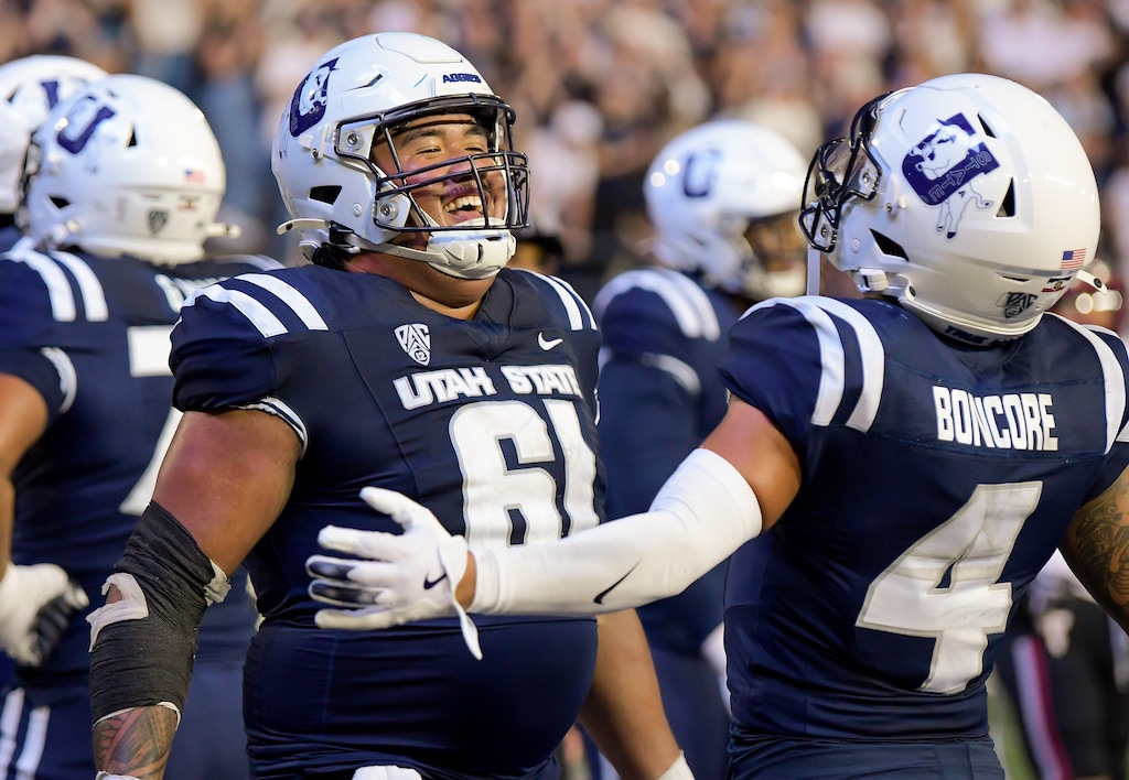 (Eli Lucero | Herald Journal) Utah State offensive lineman K'leyone Iosua (61) and wide receiver Nikko Boncore (4), shown after a game last month, celebrated again on Friday night as the Aggies beat Washington State in Logan.