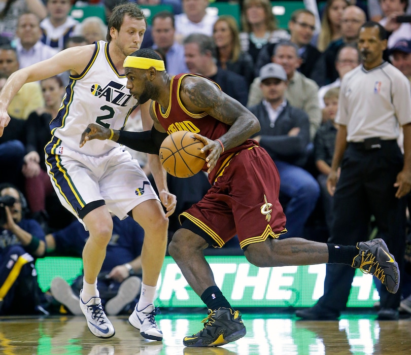 Cleveland Cavaliers' LeBron James (23) drives as Utah Jazz's Joe Ingles (2) defends in the second quarter during an NBA basketball game, Wednesday, Nov. 5, 2014, in Salt Lake City. (AP Photo/Rick Bowmer)