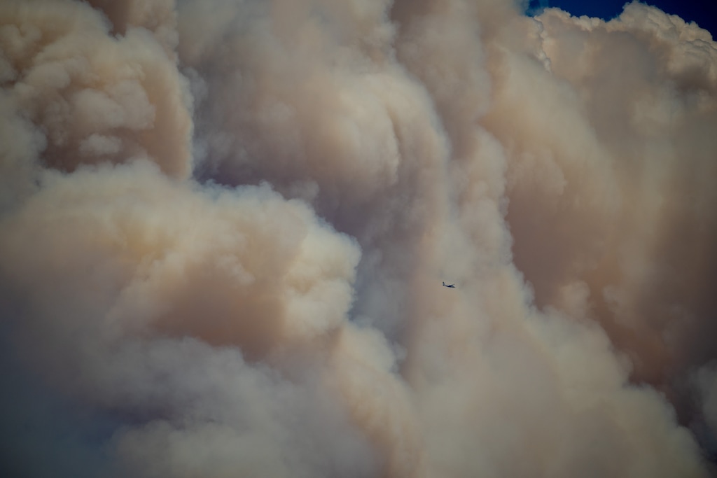(Trent Nelson  |  The Salt Lake Tribune) A spotter plan flies past a giant wall of wildfire smoke as the Cottonwood Fire burns east of Beaver on Tuesday, June 23, 2026.