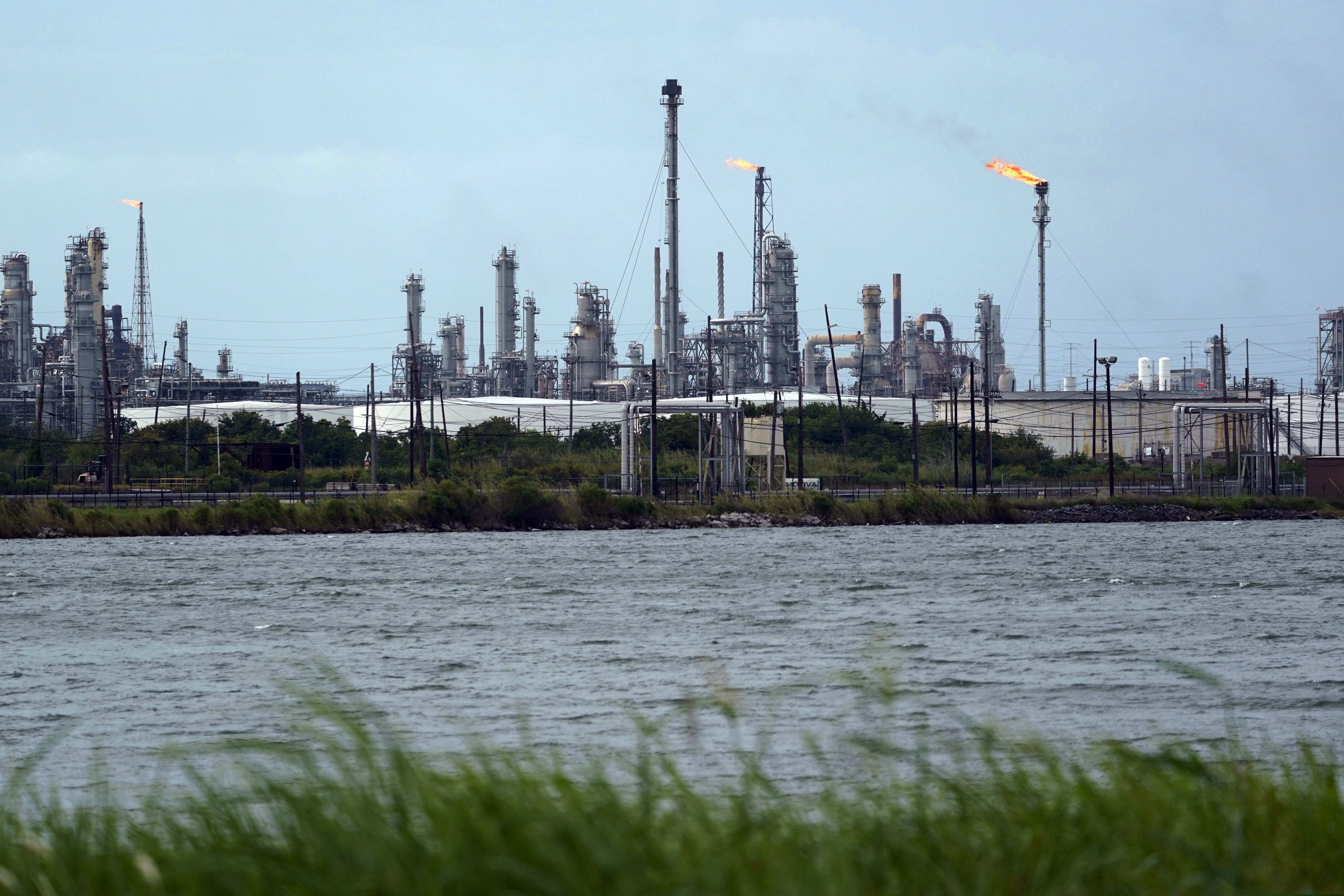 A refinery is seen along the water, Wednesday, Aug. 26, 2020, in Port Arthur, Texas. The energy industry is bracing for catastrophic storm surges and winds as Hurricane Laura cuts a dangerous path toward the coastlines of Texas and Louisiana.(AP Photo/Eric Gay)