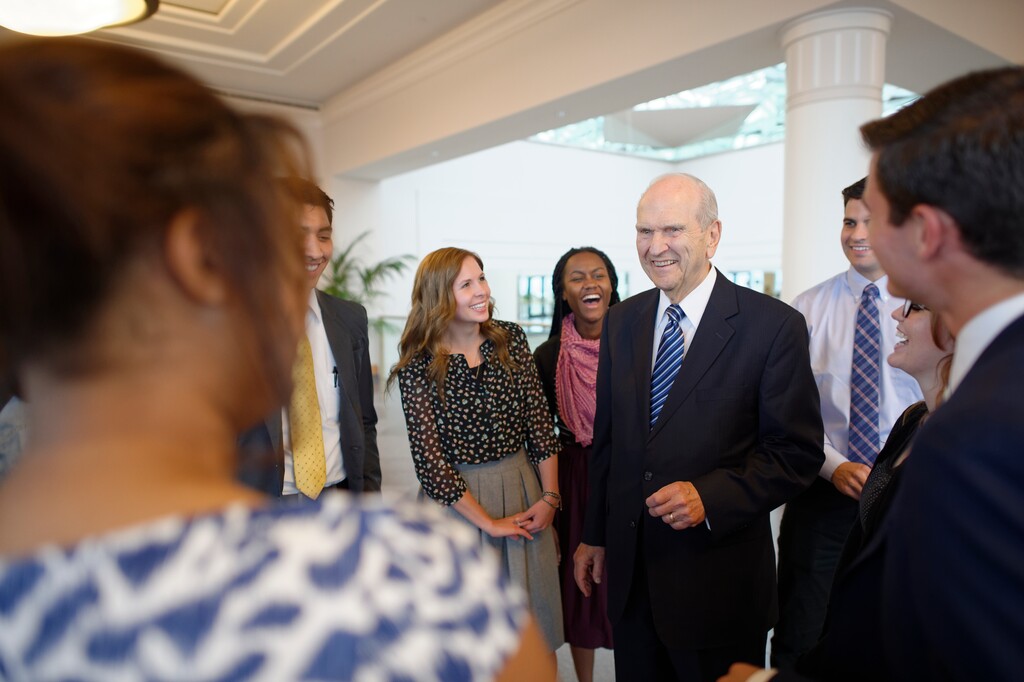 (Courtesy of the LDS Church) Young adults chat with President Russell M. Nelson in Salt Lake City. In January 2016, Nelson addressed Mormon millennials in a worldwide online broadcast from Hawaii about the faith's policy on same-sex couples and their children.