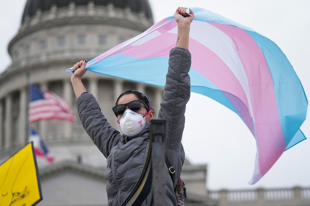 (Bethany Baker  |  The Salt Lake Tribune) A protester waves a transgender pride flag during a President's Day protest at the Utah Capitol in Salt Lake City on Monday, Feb. 17, 2025.