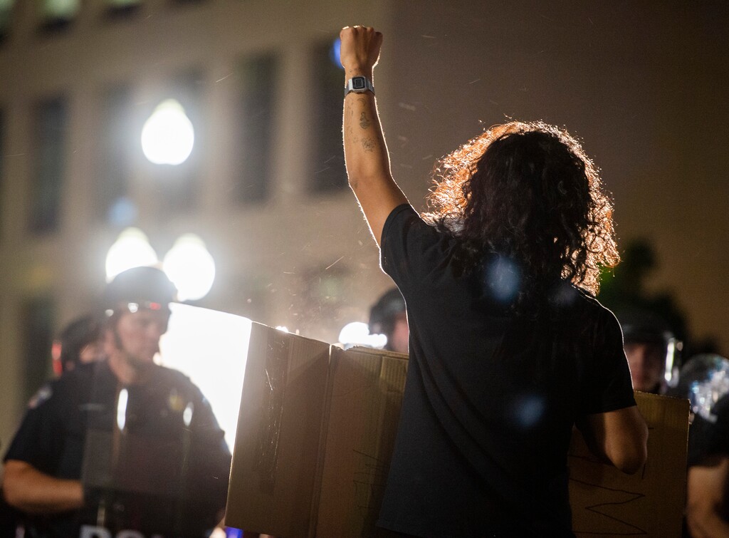 (Rick Egan  |  Tribune file photo)   A protester holds his ground as the police line moves forward in front of the library in Salt Lake City, Saturday, May 30, 2020.
