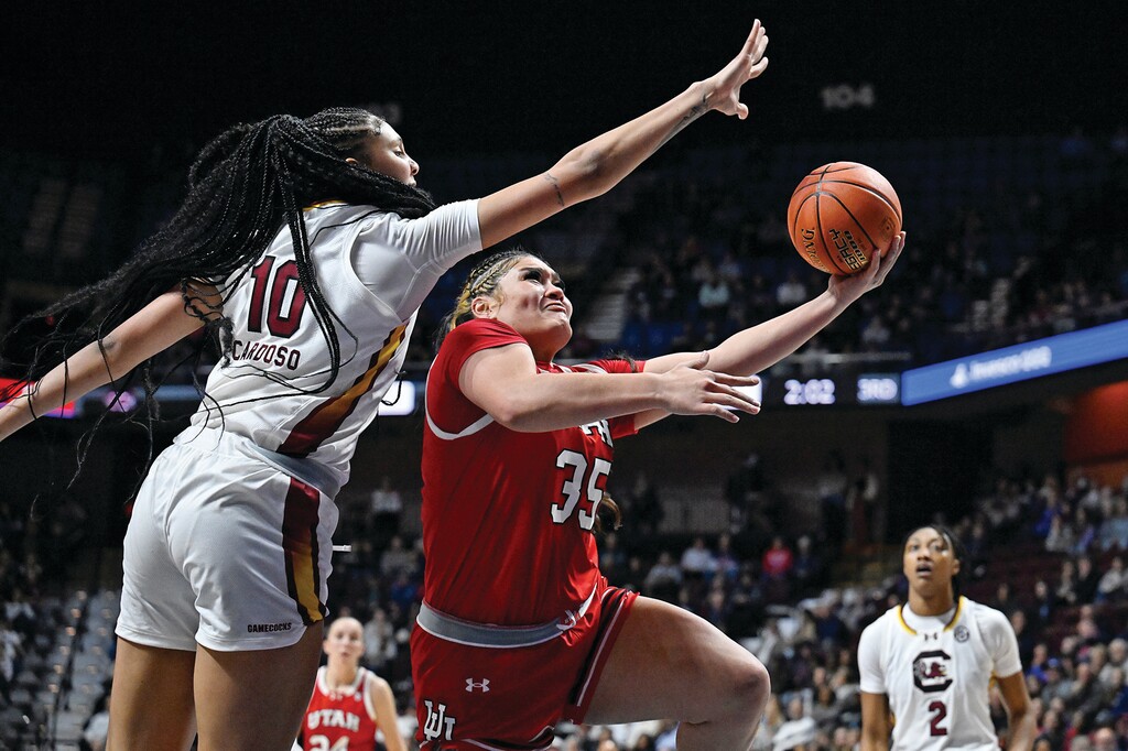 Utah forward Alissa Pili (35) shoots as South Carolina center Kamilla Cardoso (10) defends in the second half of an NCAA college basketball game, Sunday, Dec. 10, 2023, in Uncasville, Conn. (AP Photo/Jessica Hill)