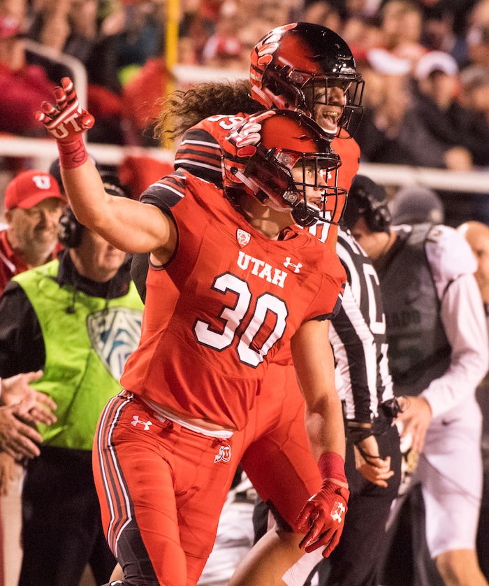 Utah Utes linebacker Cody Barton (30) and Utah Utes defensive tackle Leki Fotu (99) celebrate after forcing  Colorado Buffaloes quarterback Steven Montez (12) out of bounds for a loss of yardage, in PAC-12 football action Utah Utes vs. Colorado Buffaloes at Rice-Eccles stadium, Saturday, November 25, 2017.
