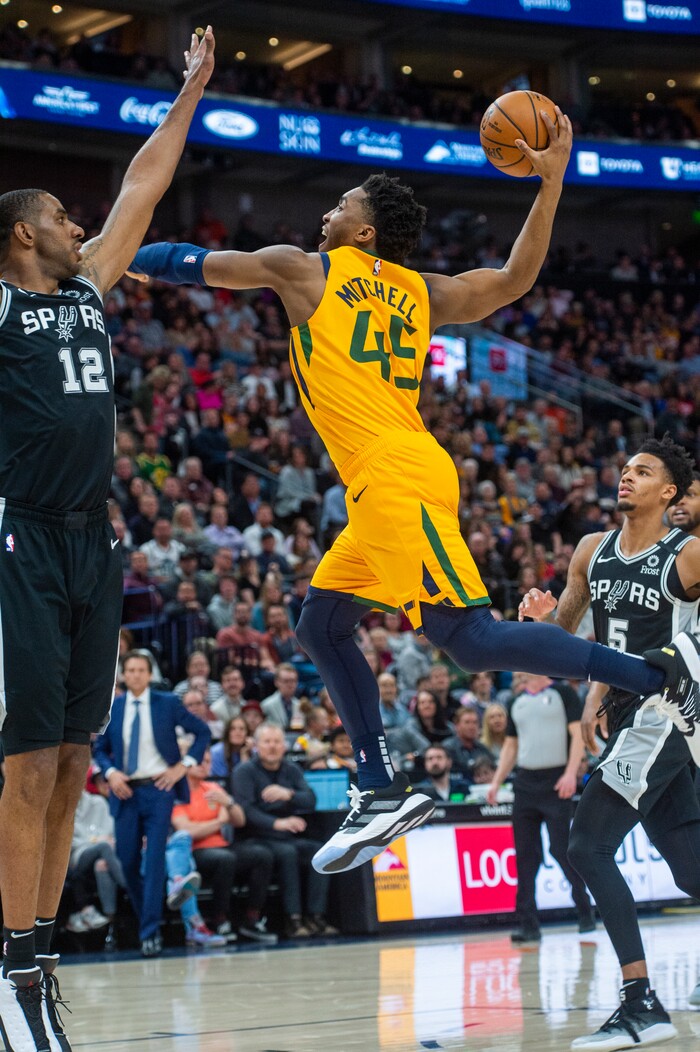 (Rick Egan  |  The Salt Lake Tribune)    
Utah Jazz guard Donovan Mitchell (45) goes in for a slam dunk, as San Antonio Spurs forward LaMarcus Aldridge (12) defends, in NBA action between the Utah Jazz and the San Antonio Spurs, in Salt Lake City, Friday, Feb. 21, 2020.