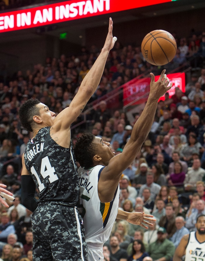 (Rick Egan  |  The Salt Lake Tribune)   Utah Jazz guard Donovan Mitchell (45) takes the ball to the hoop, as San Antonio Spurs guard Danny Green (14) defends, in NBA action, in Salt Lake City, Monday, February 12, 2018.