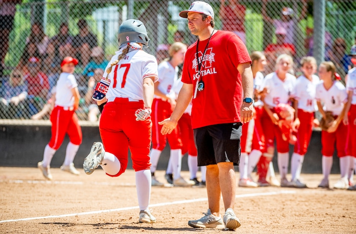 (Isaac Hale | Special to The Tribune) Mountain Ridge head coach Andre Ashton high-fives third baseman Mylee Milne (17) as she heads toward home plate after hitting a home run during the second game of a best-of-three series between the Spanish Fork Lady Dons and the Mountain Ridge Sentinels as part of the 5A state softball championship held at the Spanish Fork Sports Park on Friday, May 28, 2021.