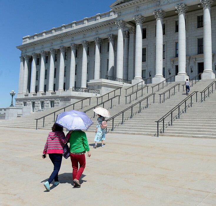 Al Hartmann  |  The Salt LakeTribuneNo rain in sight. Tuesday June 20, the hottest day of the year was a fine day for a sun umbrellas as members of a Japanese tour group protect themselves from the blazing Utah sun while visiting the state capitol. 