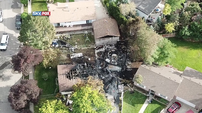 (Courtesy of FOX 13) An aerial view of the crash site where a small plane, carrying six passengers, struck a residential neighborhood in West Jordan on Saturday, July 25, 2020.