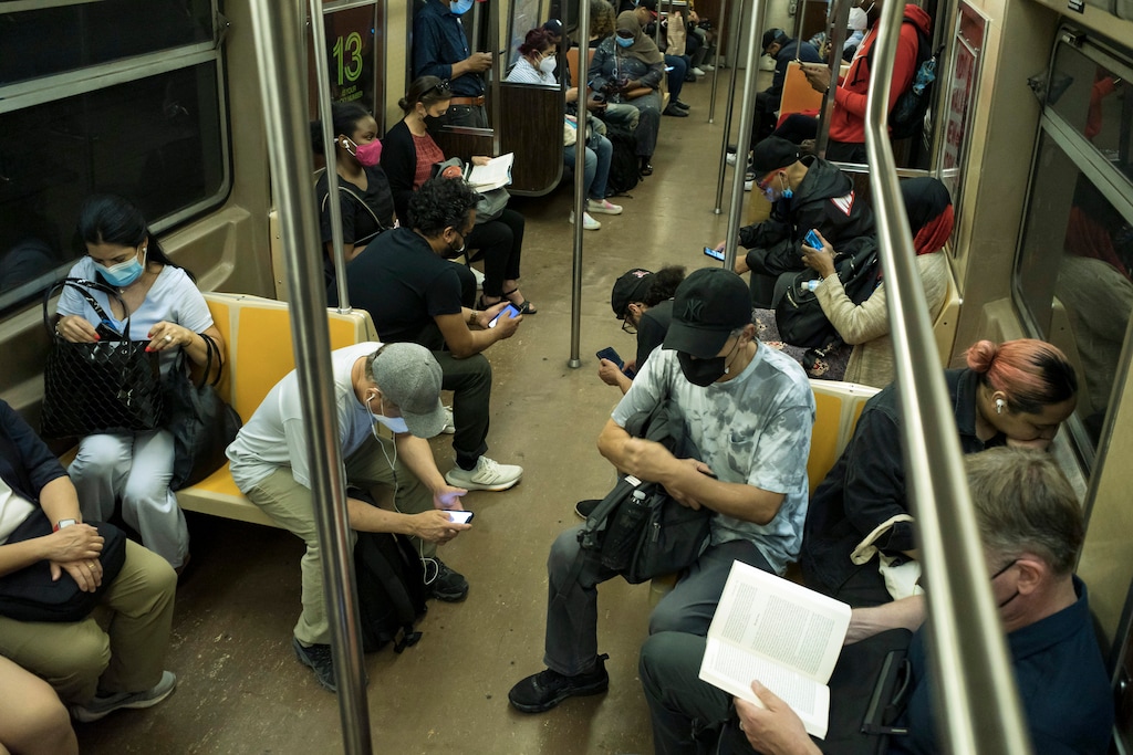 (Karsten Moran | The New York Times)

Subway riders in Manhattan on June 16, 2022. You'll enjoy talking to strangers a lot more than you think you will, as David Brooks writes.