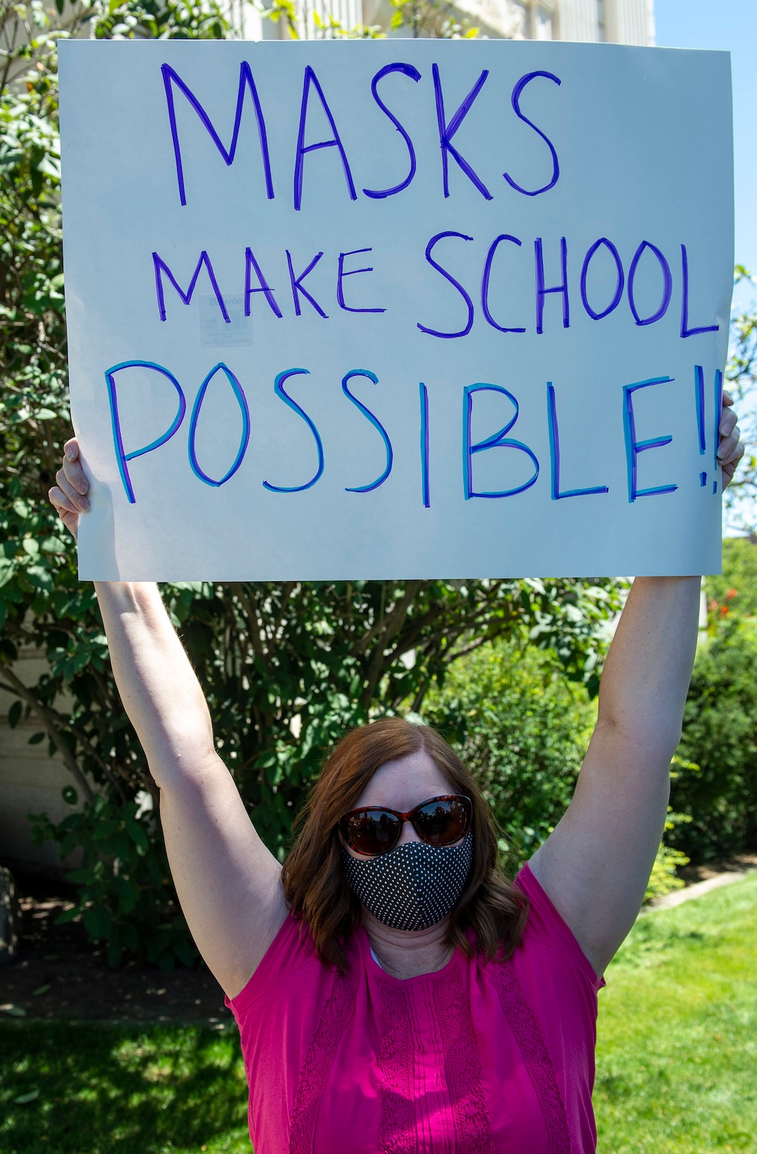 (Rick Egan  |  The Salt Lake Tribune)    Tina Cannon from Lehi wears a mask as a counter protester, during a rally protesting against masks being required in schools, before the Utah County Commission meeting in Provo, on Wednesday, July 15, 2020.