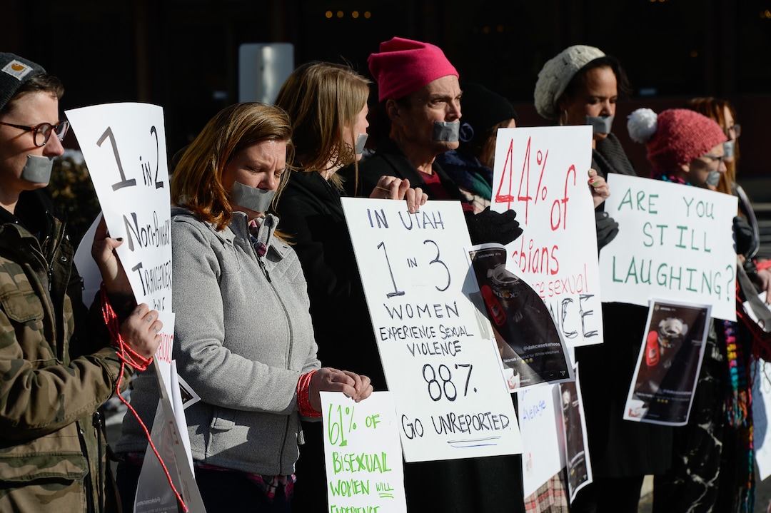 (Francisco Kjolseth  |  The Salt Lake Tribune)  Activists in Utah gather outside of Salt City Tattoo on Friday, Dec. 22, 2017, to protest following an Instagram post made by the shop's official Instagram account. The post in question was of a gift provided during the shop's white elephant exchange, a gift one of the artists at the parlor called a "rape kit," containing leather gloves, black duct tape, a bottle of lubricant, rope, and a knife.