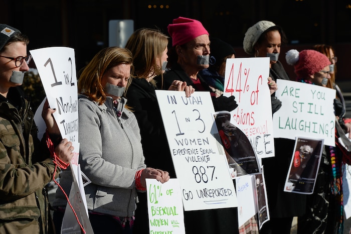 (Francisco Kjolseth | The Salt Lake Tribune) Activists in Utah gather outside of Salt City Tattoo on Friday, Dec. 22, 2017, to protest following an Instagram post made by the shop's official Instagram account. The post in question was of a gift provided during the shop's white elephant exchange, a gift one of the artists at the parlor called a "rape kit," containing leather gloves, black duct tape, a bottle of lubricant, rope, and a knife.