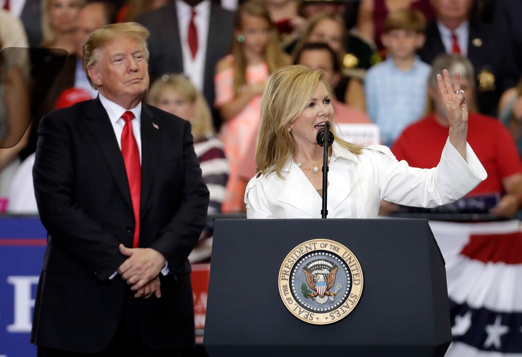 FILE - In this May 29, 2018, file photo, President Donald Trump listens as Rep. Marsha Blackburn, R-Tenn., speaks at a rally in Nashville, Tenn. Blackburn and former Gov. Phil Bredesen face only nominal primary opposition in their race to replace retiring Republican Sen. Bob Corker. (AP Photo/Mark Humphrey, File)