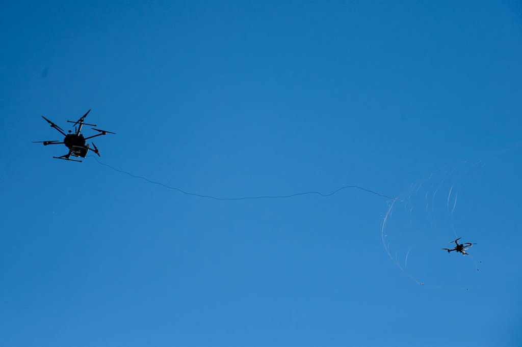 (Trent Nelson | The Salt Lake Tribune) A drone hunter, left, fires a net at another drone to capture it during a demonstration at the ribbon cutting for Deseret Unmanned Aerial Systems in Tooele, Wednesday Oct. 24, 2018.
