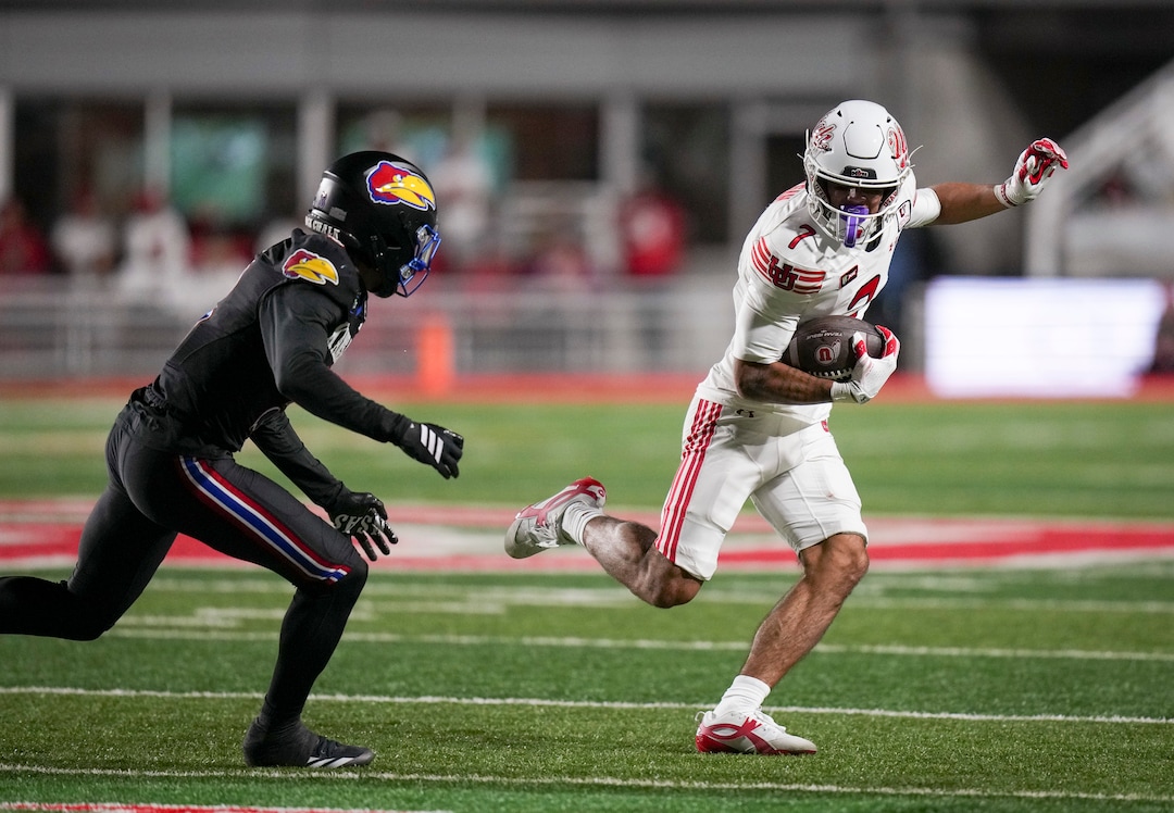 (Bethany Baker  |  The Salt Lake Tribune) Utah Utes wide receiver Braden Pegan (7) avoids a tackle from Kansas Jayhawks safety Corey Gordon (3) during the game between the Utah Utes and the Kansas Jayhawks at Rice-Eccles Stadium in Salt Lake City on Saturday, Oct. 10, 2026.