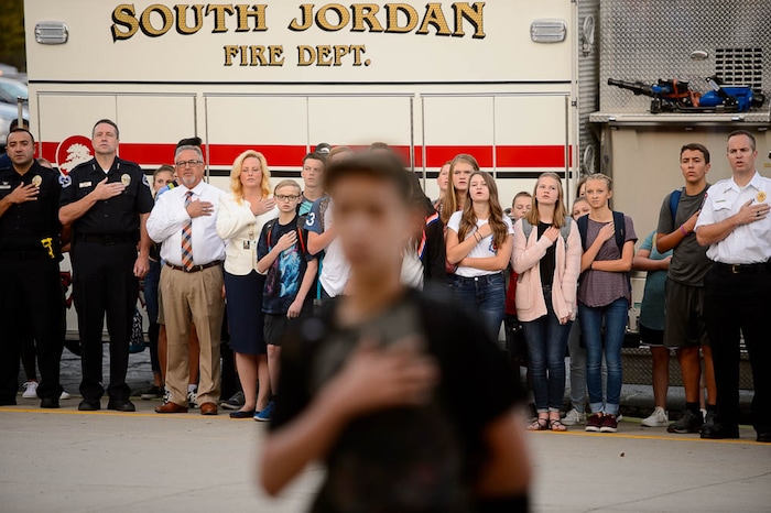 (Trent Nelson | The Salt Lake Tribune)
First responders, students and staff recite the Pledge of Allegiance at South Jordan Middle School during a sunrise ceremony to mark the anniversary of 9/11, Tuesday Sept. 11, 2018.