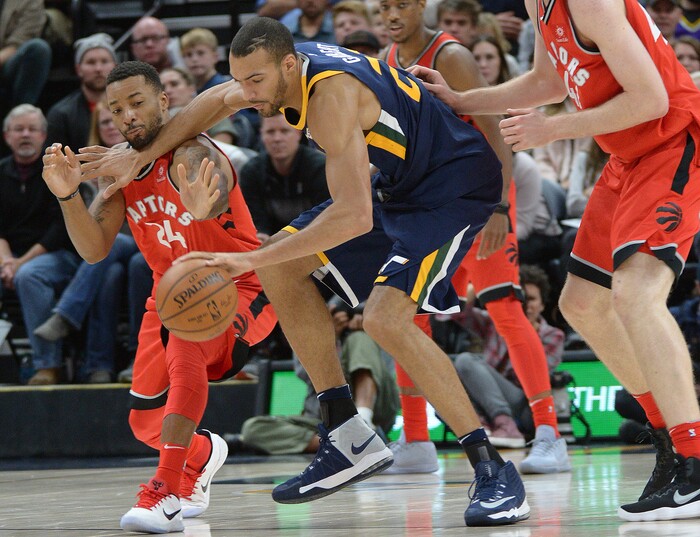 (Leah Hogsten  |  The Salt Lake Tribune) Utah Jazz center Rudy Gobert (27) plays keep away from Toronto Raptors forward Norman Powell (24). The Utah Jazz were defeated by the Toronto Raptors 100-109 at Vivint Smart Home Arena, Friday, November 3, 2017