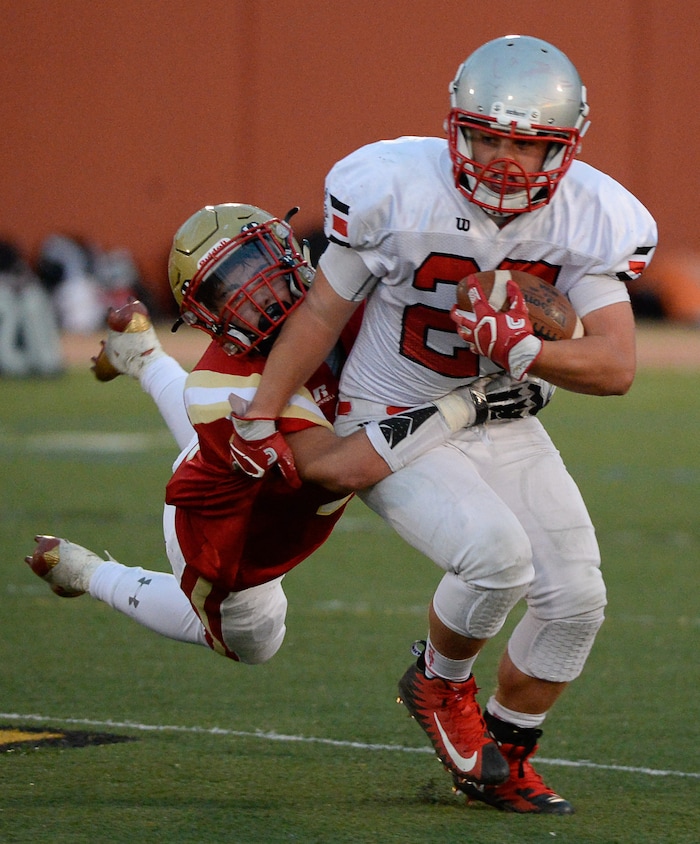 (Francisco Kjolseth  |  The Salt Lake Tribune)  Blaine Cockett of Judge goes for a ride as he tries to take down Jace Miller of Manti in the Class 3A football playoff game in the Class 3A football playoff game at Judge Memorial on Thursday, Oct. 19, 2017. 