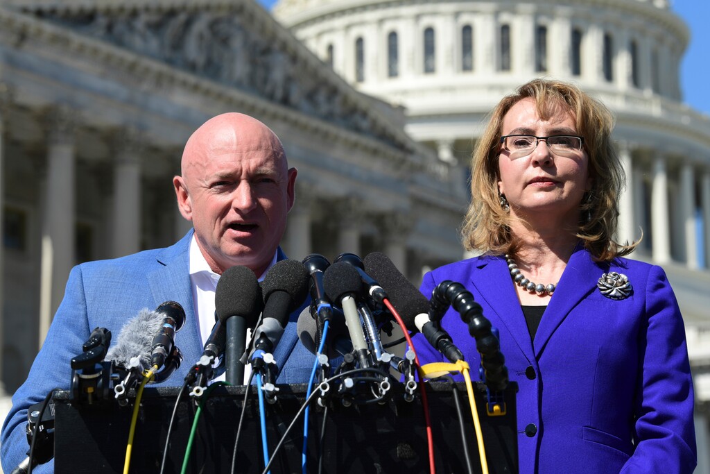 Former Rep. Gabrielle Giffords, D-Ariz., right, listens as her husband, Mark Kelly, left, speaks on Capitol Hill in Washington, Monday, Oct. 2, 2017, about the mass shooting in Las Vegas. Giffords was a congresswoman when she was shot in an assassination attempt in 2011. (AP Photo/Susan Walsh)