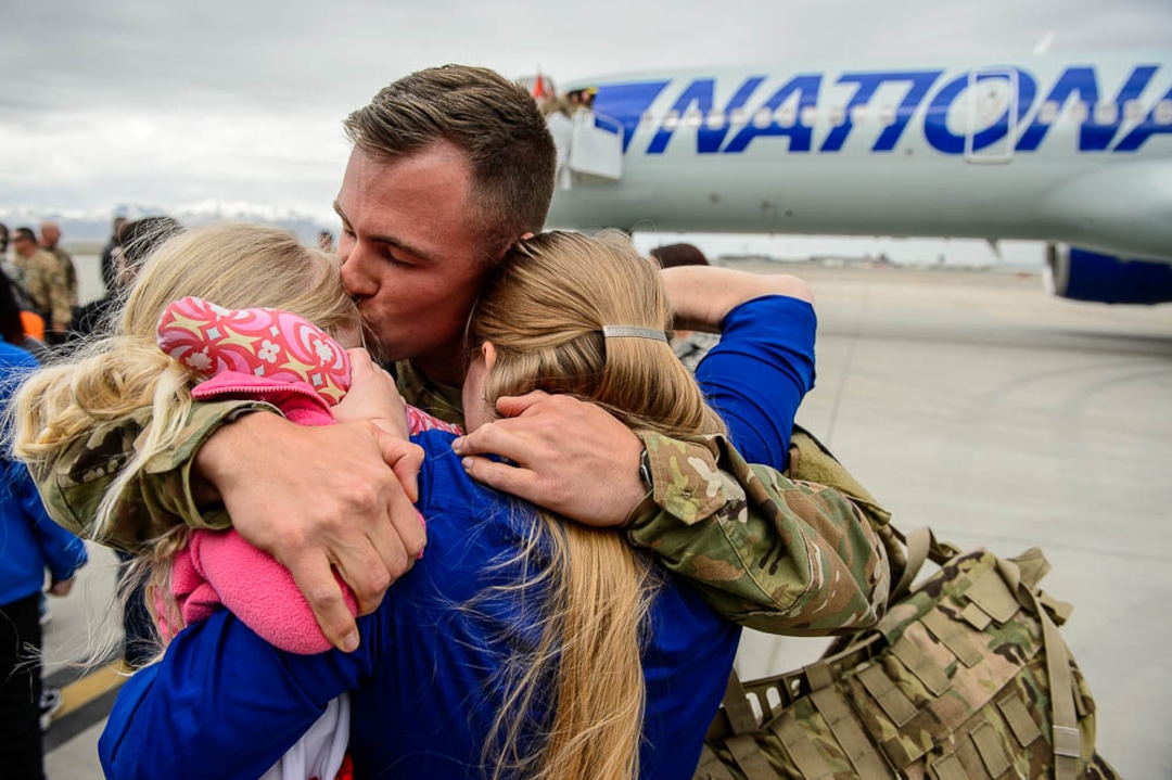 (Trent Nelson  |  The Salt Lake Tribune)  Sergeant Chris Jackson is welcomed home by his wife Kalee and daughter Emma as almost 100 Soldiers from Utah Army National Guard’s Echo Battery, 1st Battalion, 145th Field Artillery, “Big Red” return after a 10-month Middle East deployment, on Tuesday April 9, 2019 at Wright Air Base in Salt Lake City.