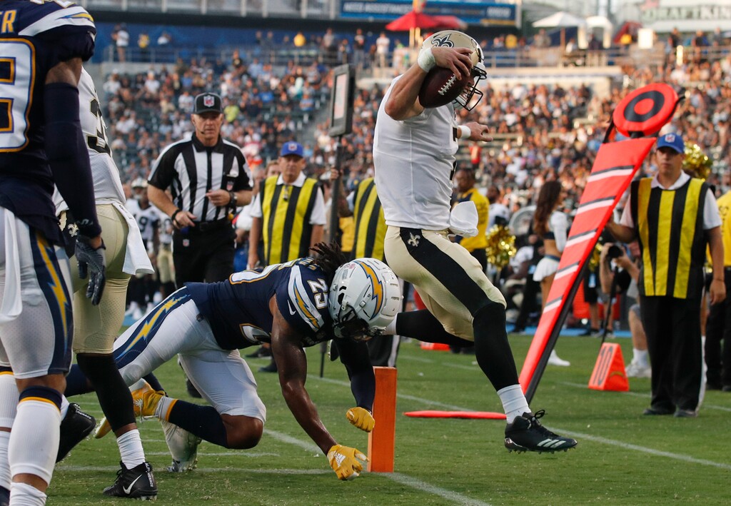 New Orleans Saints quarterback Taysom Hill, right, scores a touchdown as Los Angeles Chargers defensive back Rayshawn Jenkins tries to push him out of bounds during the second half of an NFL preseason football game Saturday, Aug. 25, 2018, in Carson, Calif. (AP Photo/Jae C. Hong)