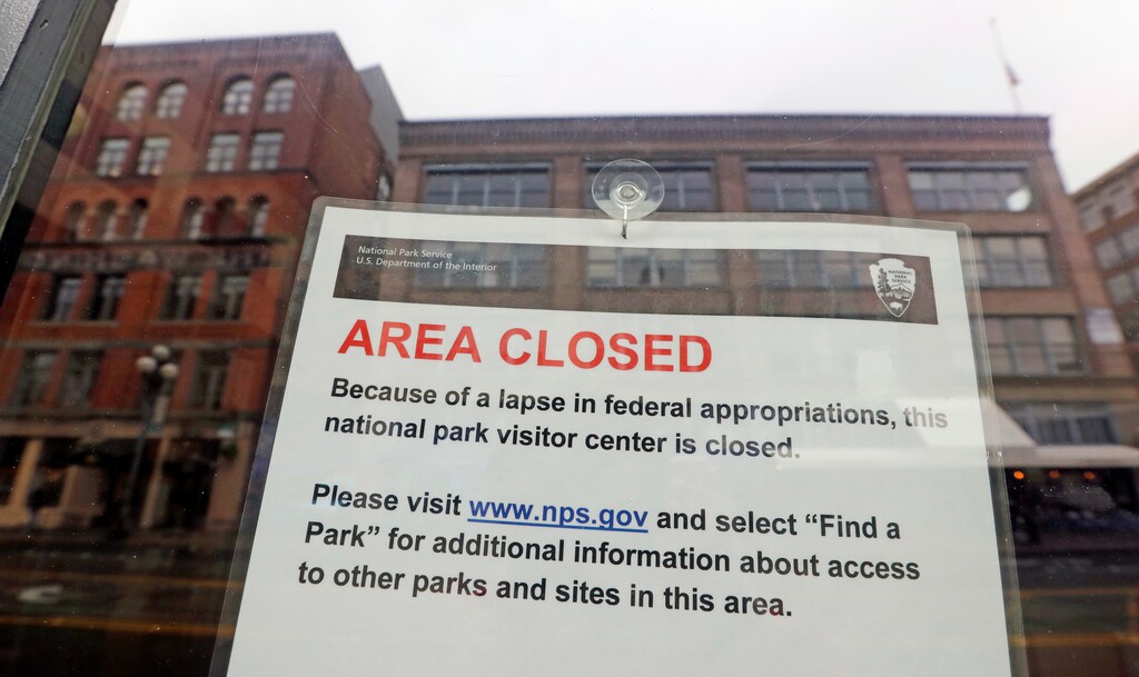 (Elaine Thompson | Associated Press) The tiny Klondike Gold Rush National Historical Park in Seattle's historic Pioneer Square neighborhood is posted with a closed sign as part of the federal government shutdown Wednesday, Dec. 26, 2018. The shutdown started Saturday, Dec. 22, when funding lapsed for nine Cabinet-level departments and dozens of agencies.