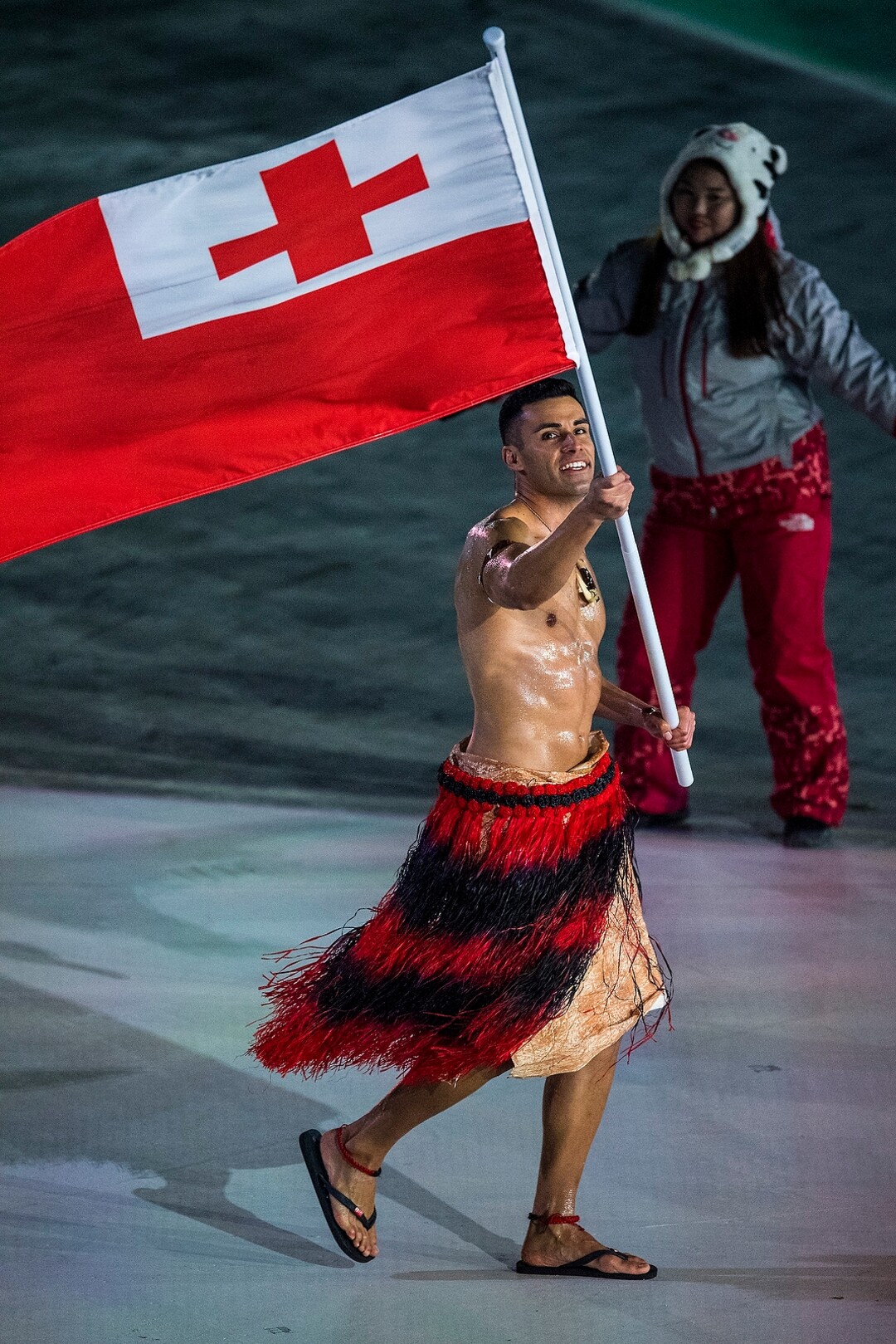 (Chris Detrick  |  The Salt Lake Tribune)  Pita Taufatofua carries the flag of Tonga during the Pyeongchang 2018 Winter Olympics opening ceremony at Olympic Stadium Friday, February 9, 2018.  