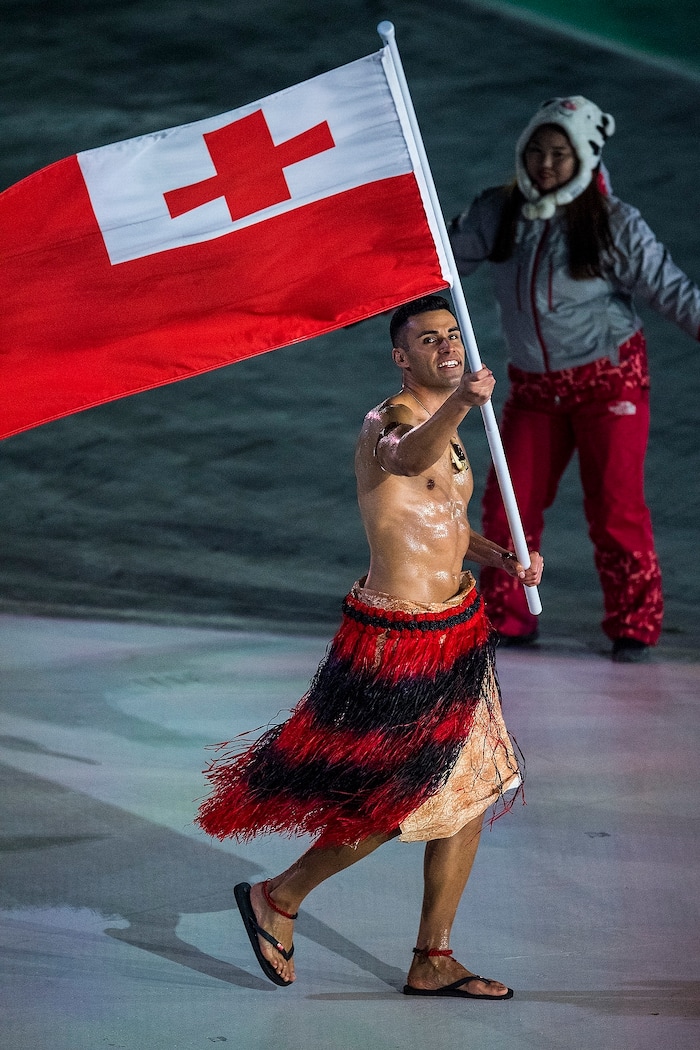 (Chris Detrick  |  The Salt Lake Tribune)  Pita Taufatofua carries the flag of Tonga during the Pyeongchang 2018 Winter Olympics opening ceremony at Olympic Stadium Friday, February 9, 2018.  