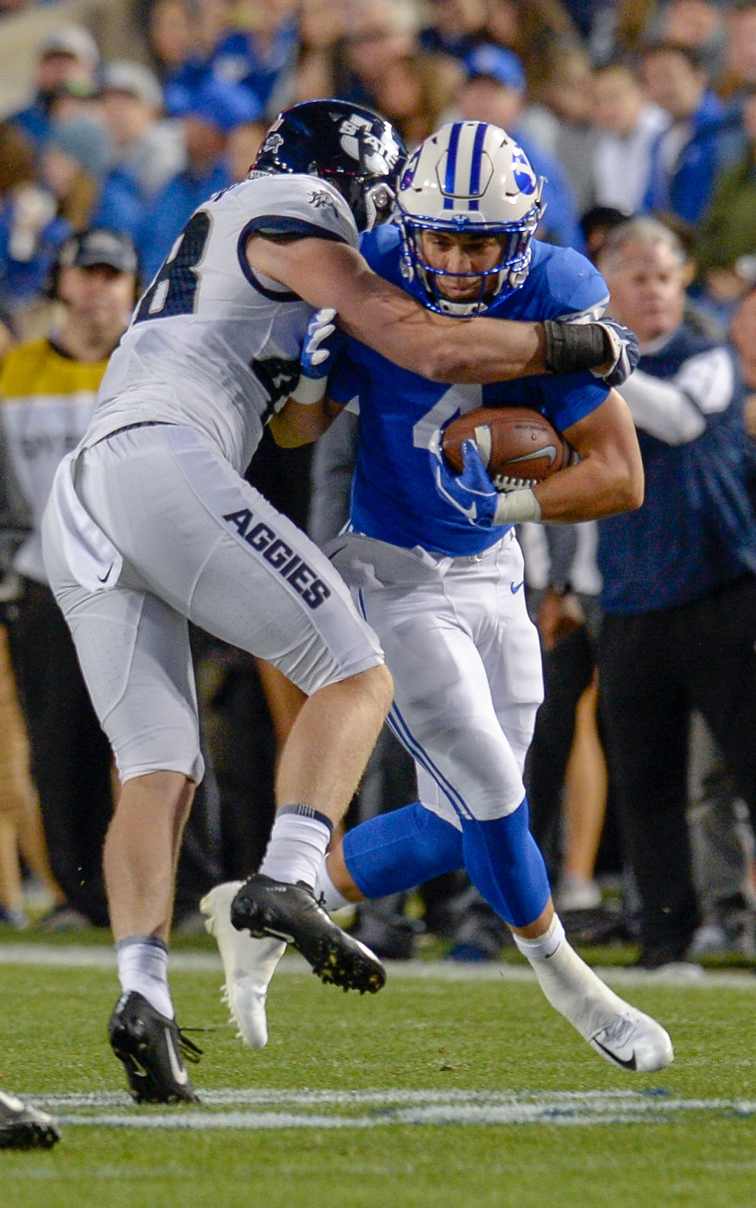 Leah Hogsten  |  The Salt Lake Tribune  Utah State Aggies linebacker Chase Christiansen (48) brings down Brigham Young Cougars running back Lopini Katoa (4)as BYU hosts Utah State University at Lavell Edwards Stadium in Provo, Friday, Oct. 5, 2018.