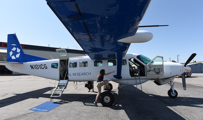 (Francisco Kjolseth  |  Francisco Kjolseth)  Amber Surrency, an aerial research photographer for CoStar Group Inc., cleans windows before a flight over Salt Lake City on Friday, June 8, 2018, on the specially equipped Cessna Grand Caravan EX. CoStar Group Inc., a research and technology company provides information to commercial real estate professionals, including those in Utah.