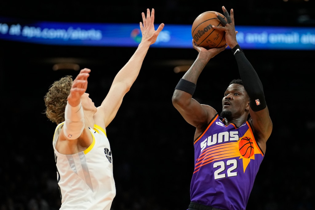 Phoenix Suns center Deandre Ayton (22) shoots over Utah Jazz forward Lauri Markkanen during the second half of an NBA basketball game Saturday, Nov. 26, 2022, in Phoenix. The Suns won 113-112. (AP Photo/Rick Scuteri)