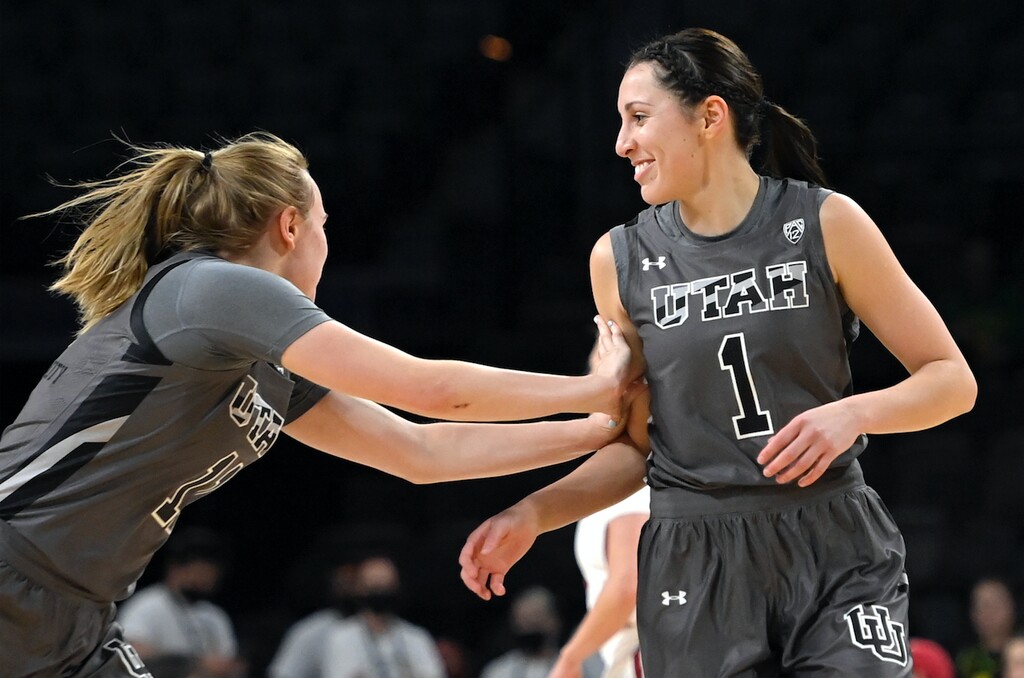 Utah guard Brynna Maxwell, left, reacts after guard Isabel Palmer (1) scored a 3-point basket against Washington State during the first half of an NCAA college basketball game in the quarterfinals of the Pac-12 women's tournament Thursday, March 3, 2022, in Las Vegas. (AP Photo/David Becker)