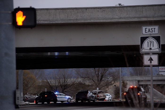 Scott Sommerdorf | The Salt Lake Tribune
The scene of a fatal crash on 3500 South, under the I-215 expressway, Sunday, February, 11, 2018. At the far left is one crashed vehicle, and in the center of the frame, another.