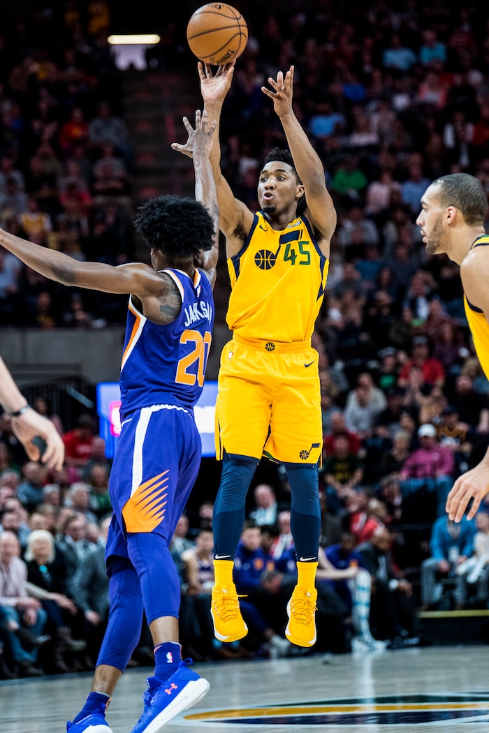 (Chris Detrick  |  The Salt Lake Tribune)  Utah Jazz guard Donovan Mitchell (45) shoots past Phoenix Suns guard Josh Jackson (20) during the game at Vivint Smart Home Arena Thursday, March 15, 2018. Utah Jazz defeated Phoenix Suns 116-88.