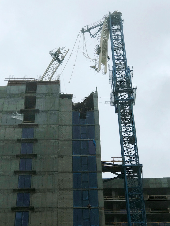A crane atop a high-rise under construction in downtown Miami collapsed Sunday, Sept. 10, 2017, amid strong winds from Hurricane Irma. The crane collapsed in a bayfront area filled with hotels and high-rise condo and office buildings, near AmericanAirlines Arena, according to a tweet from the City of Miami. (Gideon J. Ape via AP)