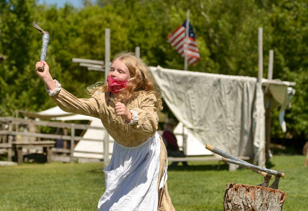 (Leah Hogsten  |  The Salt Lake Tribune) Madyson Mason, 10, learns how to throw a hatchet during Pioneer Day festivities at the American West Heritage Center in Wellsville, July 24, 2020.