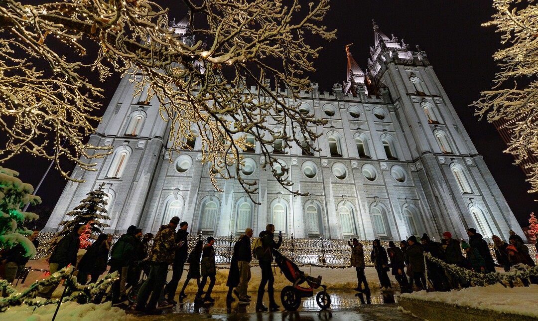 (Francisco Kjolseth  |  The Salt Lake Tribune)  Visitors take in the sights as Temple Square in Salt Lake City comes to life Friday, November 29, 2019, as hundreds of thousands of colorful LED bulbs light up, a yearly tradition that started in 1965. The lights will run through the end of the year.