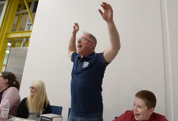 (Scott Sommerdorf | The Salt Lake Tribune)
Real Salt Lake Academy math teacher Steve Mond reacts toward students after he was shown correctly answering a question about the rapper Tupac during the watch party at the school, Friday, May 11, 2018, as they showed his performance in the JEOPARDY! Teachers Tournament.